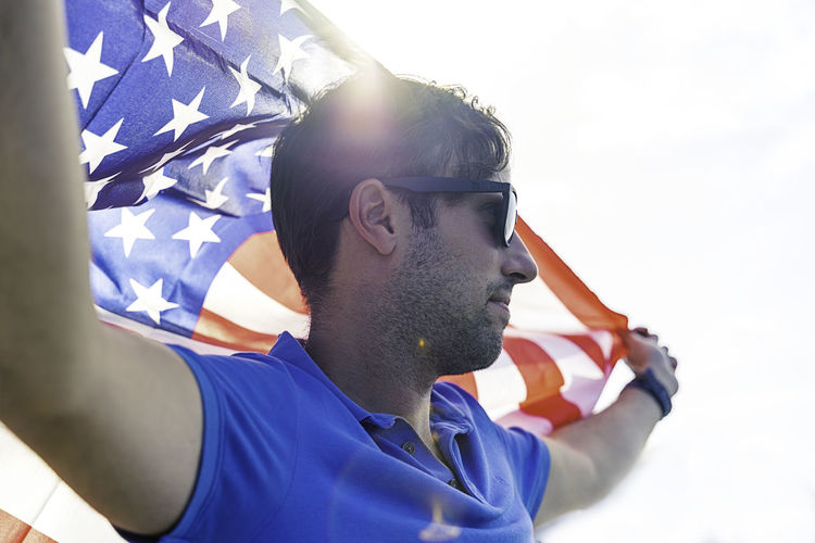 Portrait of young man against flag