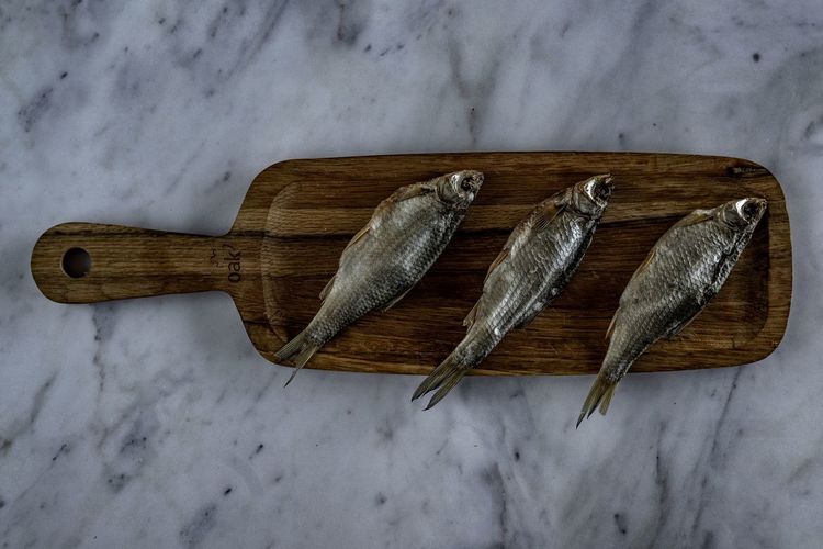 High angle view of fish on cutting board