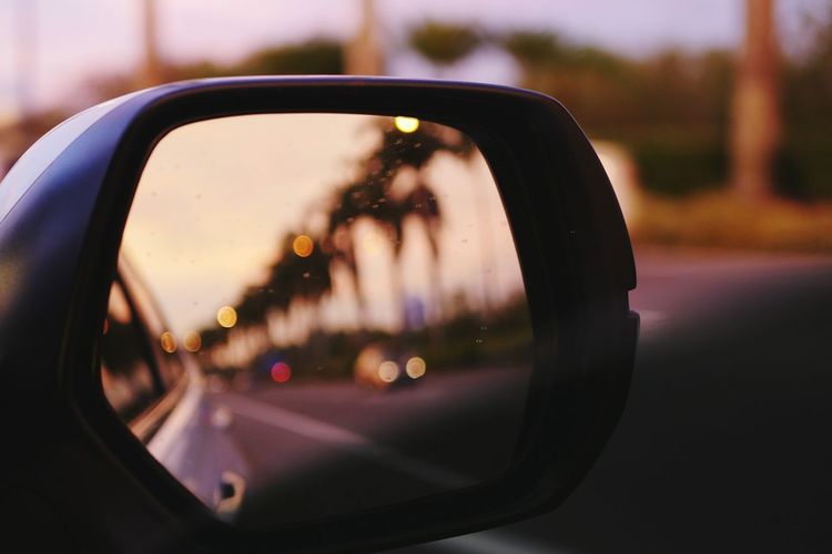 Reflection in side-view mirror of car