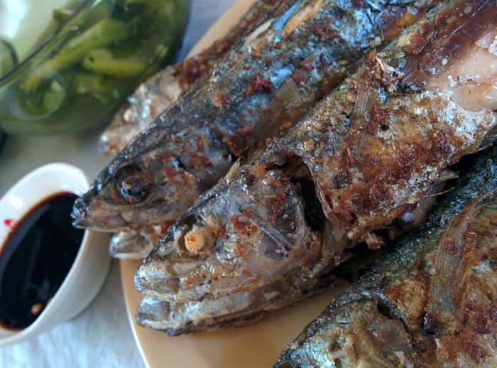 High angle view of fresh fried fish served in plate on table at restaurant