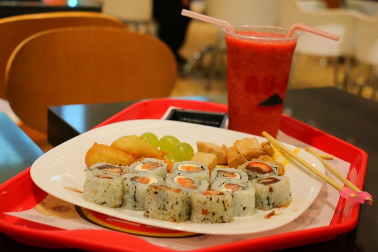 Close-up of fresh meal served in plate with juice on table at restaurant