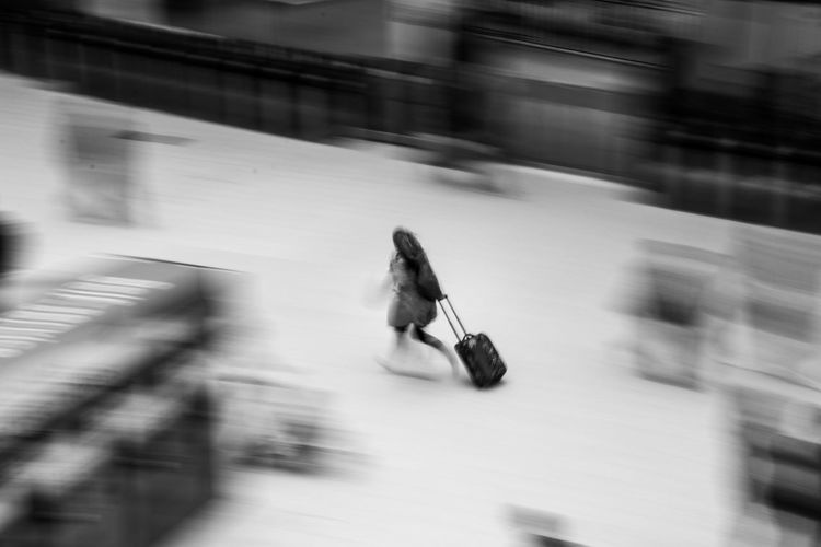 Blurred motion of running people in train station