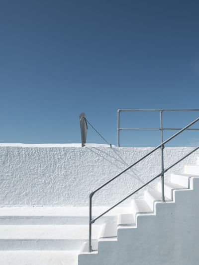 Staircase on stairs against clear sky