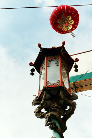 Low angle view of lantern hanging against sky