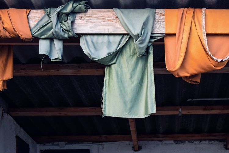 Clothes hanging on ceiling at home