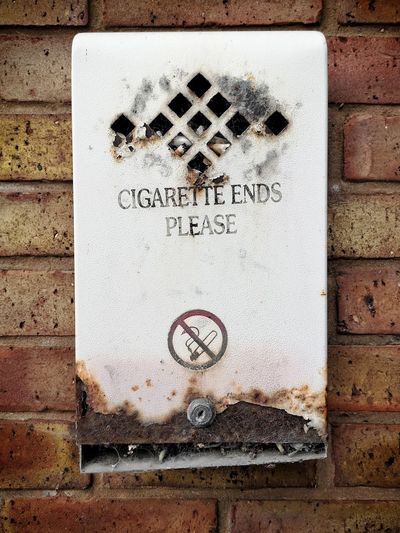 Close-up of text on brick wall
