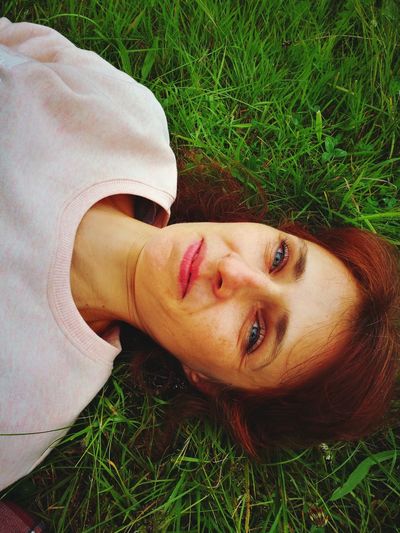 Portrait of smiling woman lying on land