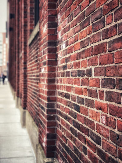 Close-up of brick wall in alley
