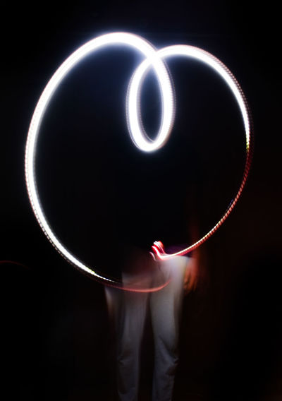 Digital composite image of person holding light painting