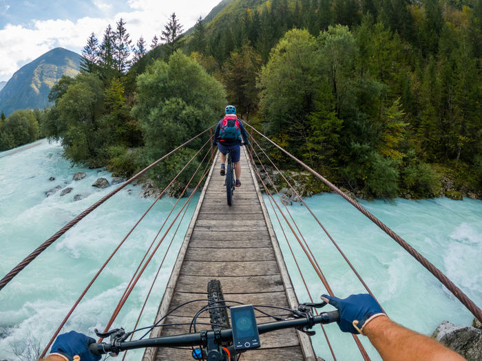 Gopro first person view mountain biking on  wooden suspension bridge above soca river, slovenia.