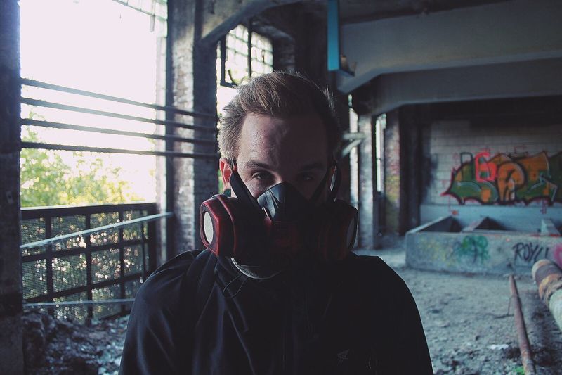 Portrait of man wearing gas mask in abandoned building