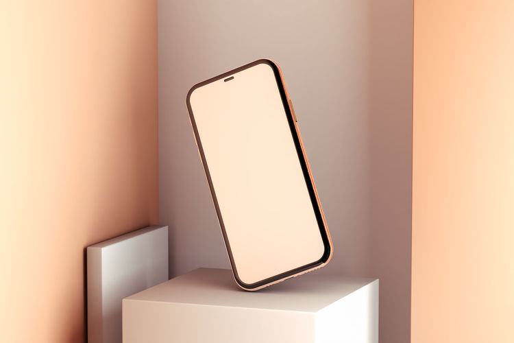 Close-up of mobile phone against wall
