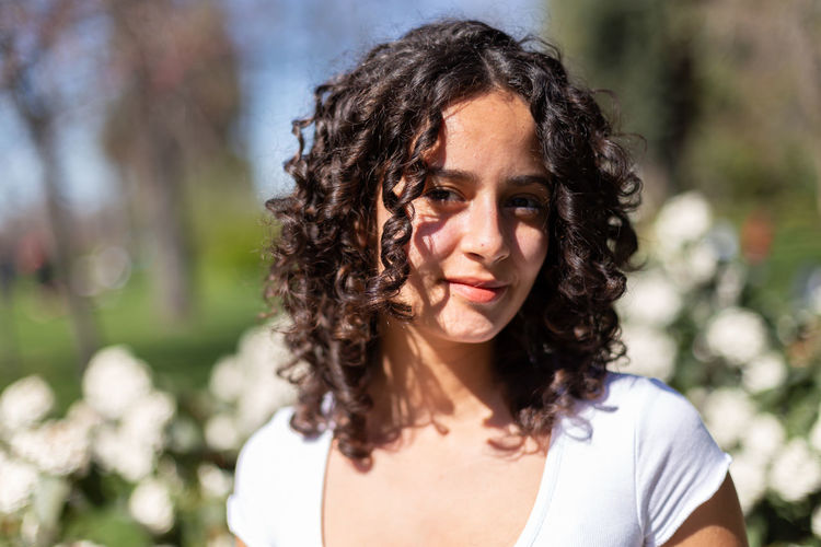 Portrait of young woman standing outdoors