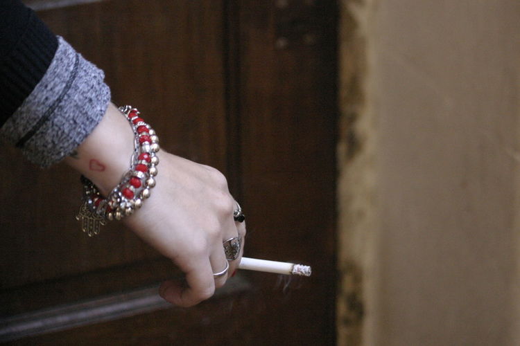 Cropped hand of woman holding cigarette