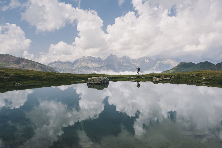 Young woman hiking with her son in the baby carrier at the pyrenees