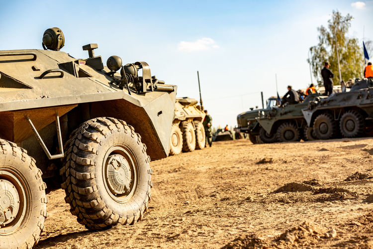 Tank on field against sky