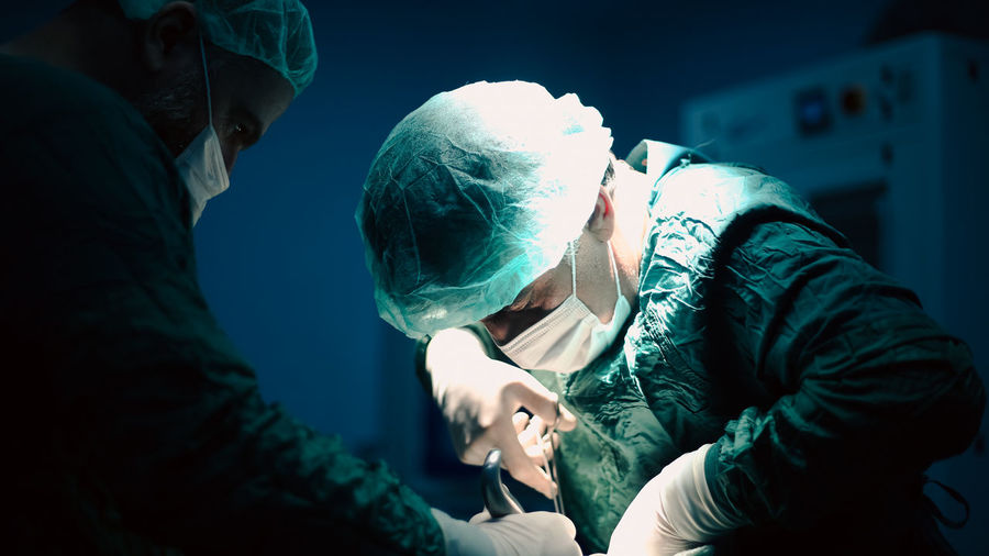 Doctors performing an appendectomy surgery, surgical concept.
