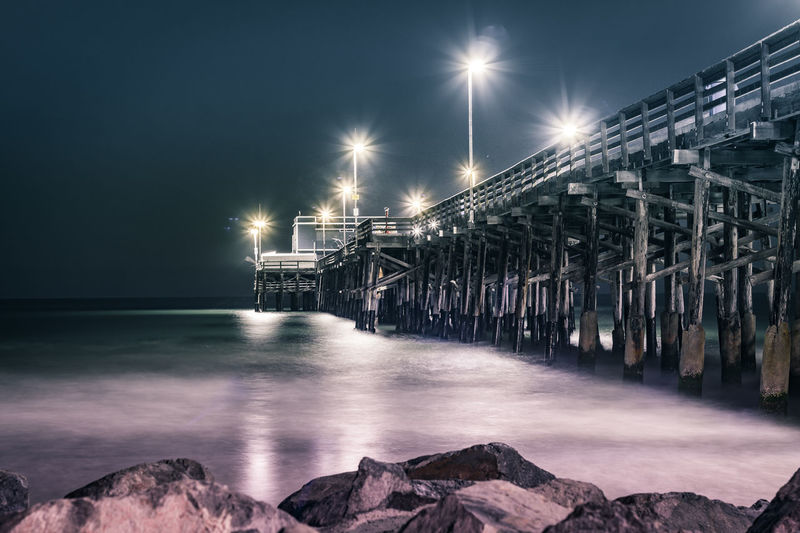 Illuminated pier at night