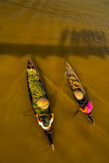 High angle view of people rowing boats on lake