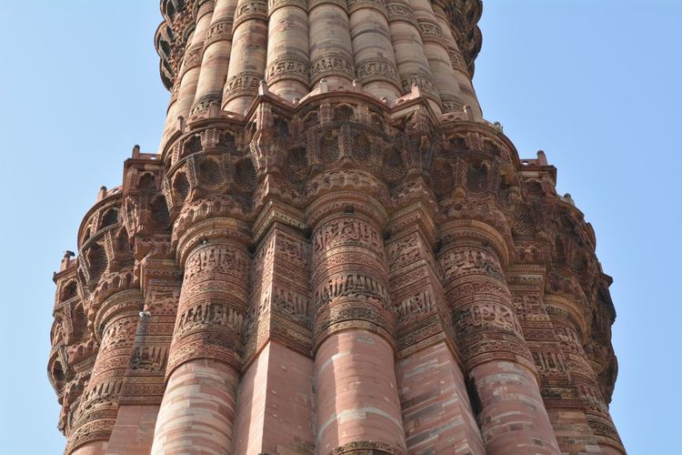 Low angle view of qutb minar against clear sky in city