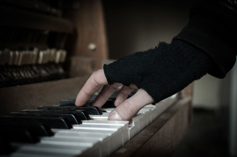 Cropped image of hand playing piano