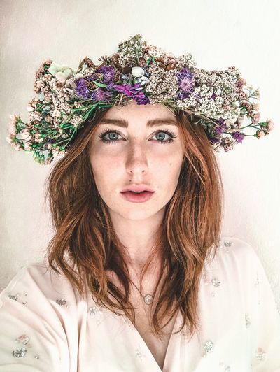 Portrait of beautiful young woman wearing flowers