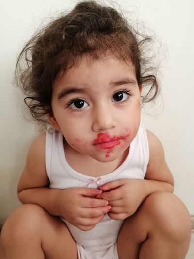 Portrait of cute baby girl sitting at home