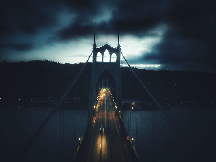 Illuminated bridge against sky at night