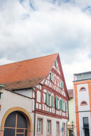 Low angle view of building against cloudy sky