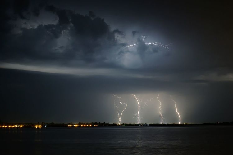 Lightning over lake at night