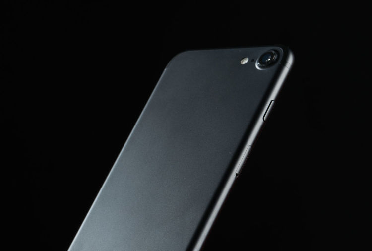 High angle view of mobile phone against black background