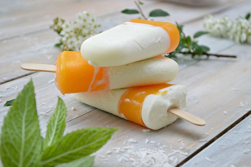 Close-up of popsicles with herbs on wooden table