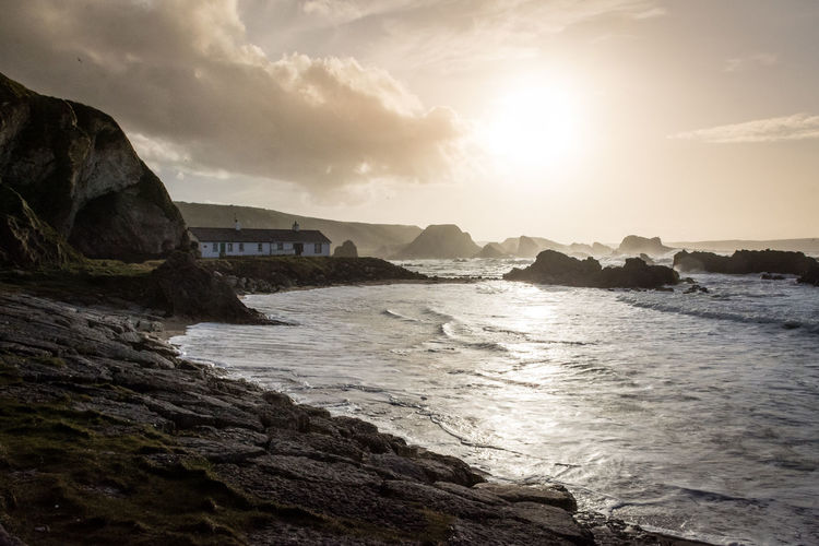 Scenic view of sea and cottage, at ballintoy harbour
