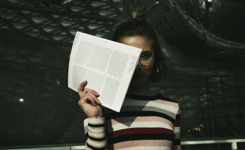 Portrait of woman photographing book