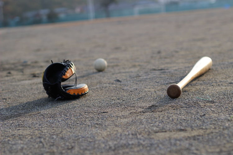 Baseball bat and glove on playing field