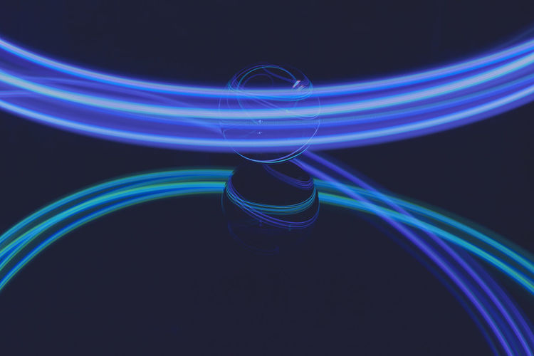 Close-up of light paintings against black background
