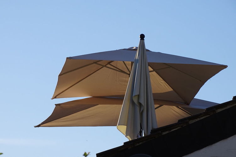 Low angle view of built structure against clear blue sky