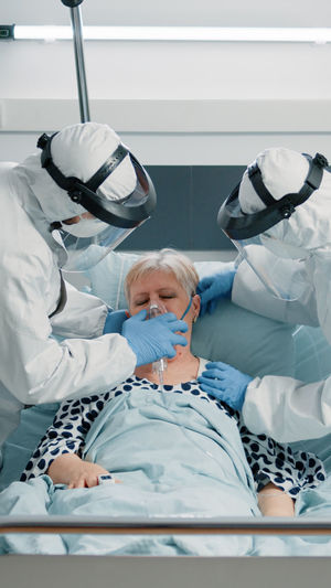 High angle view of female doctor examining patient in hospital