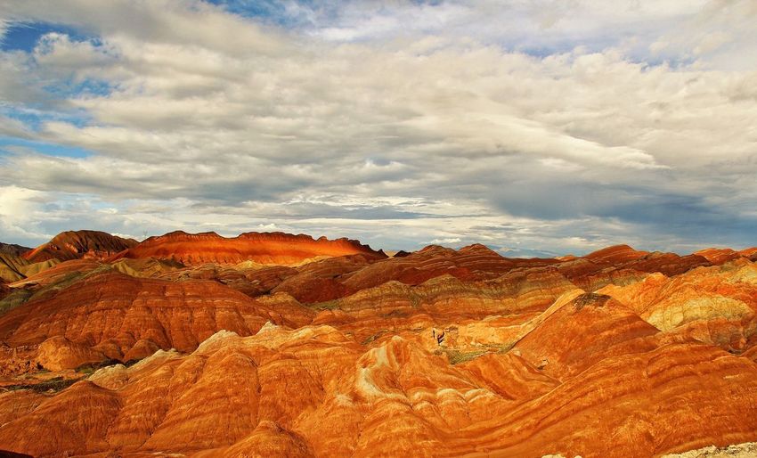 Scenic view of zhangye danxia national geological park against cloudy sky