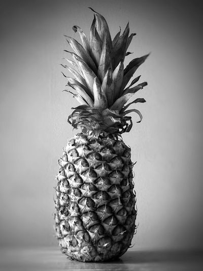 Close-up of pineapple on table against white background
