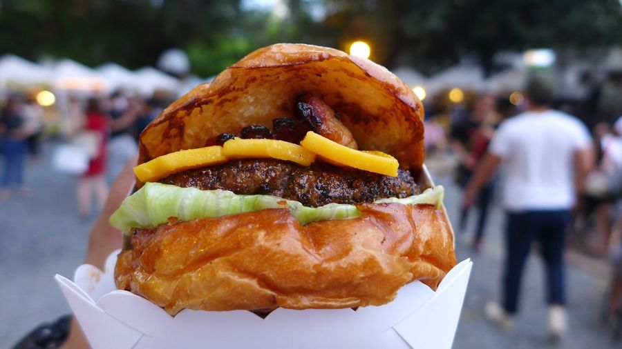 Close-up of cropped hand holding burger