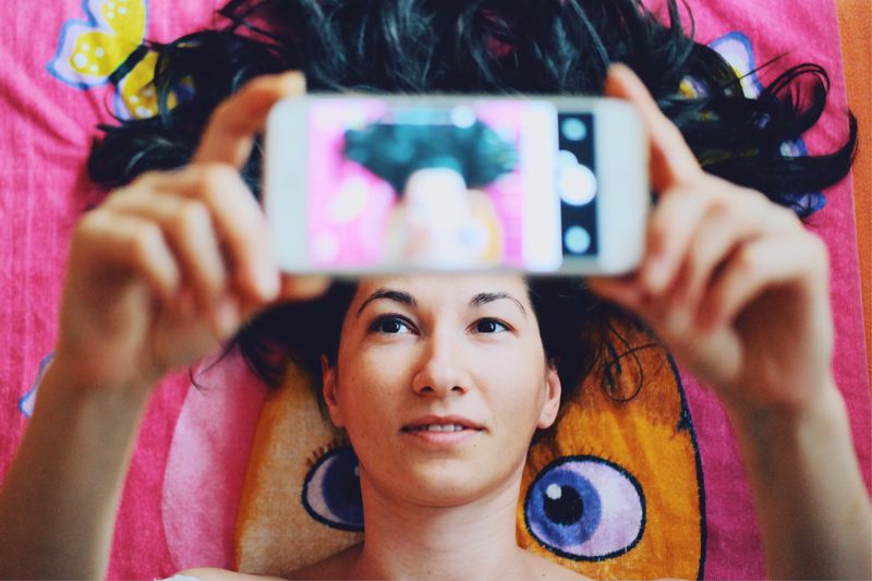 High angle view of young woman taking selfie