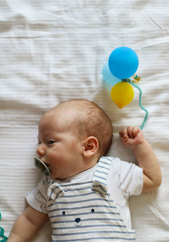 Portrait of cute baby boy with toy