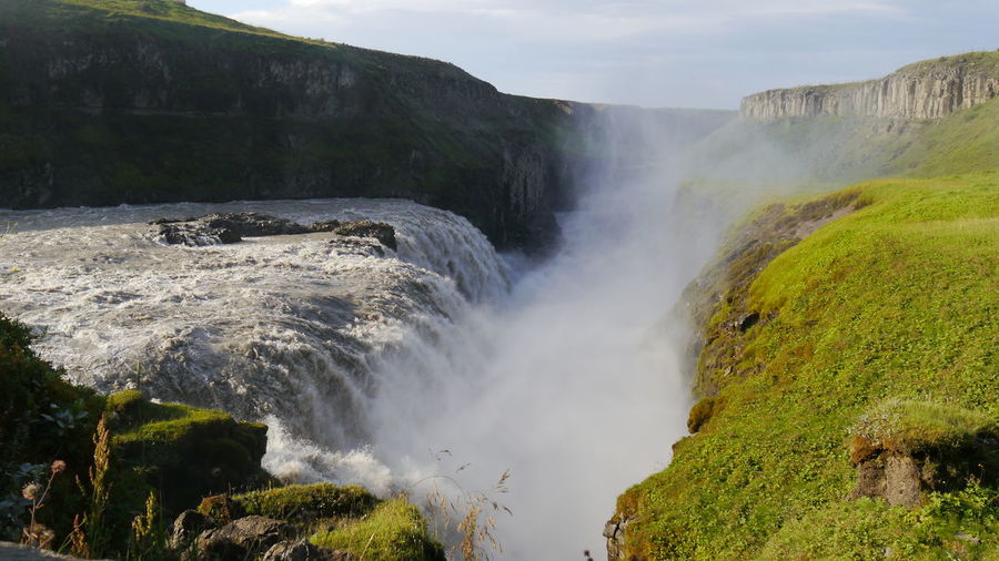 Scenic view to power of water at gullfoss waterfall, iceland