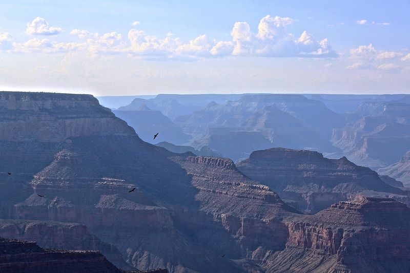 Scenic view of mountains and valley and grand canyon against sky