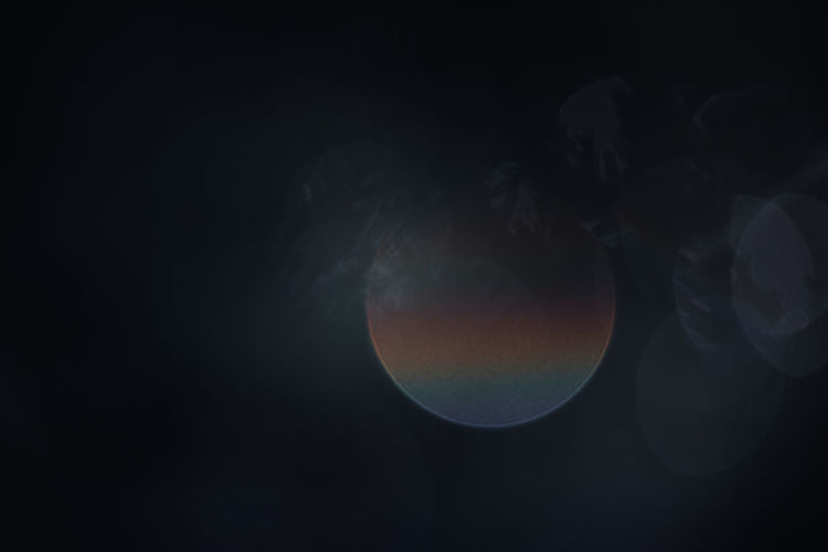 DIGITAL COMPOSITE IMAGE OF MOON AGAINST DARK BACKGROUND