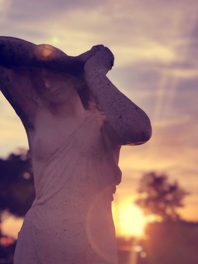 Close-up of statue against sky during sunset
