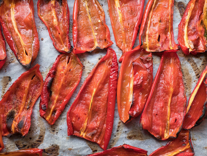 Close-up of roasted red peppers on baking paper