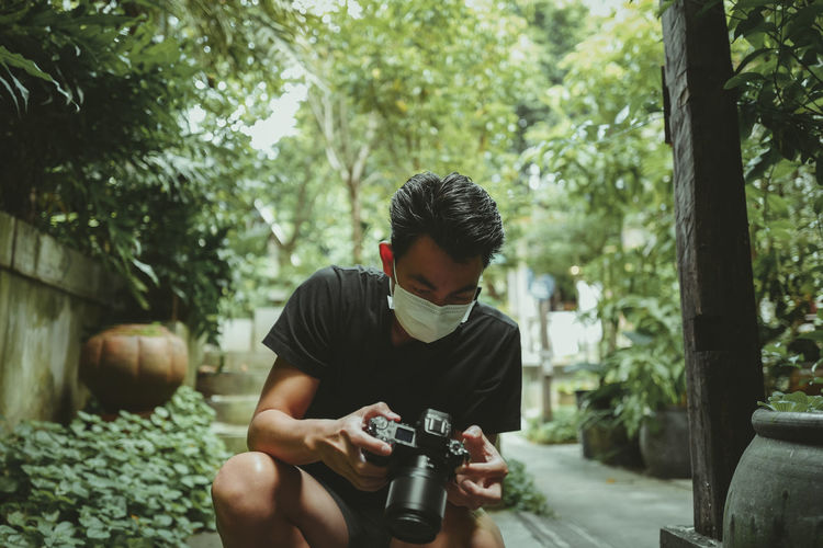 Cinematic style of young man using his camera , inspiration and travel concept