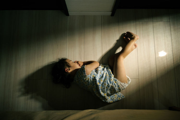 Young woman lying down on bed at home